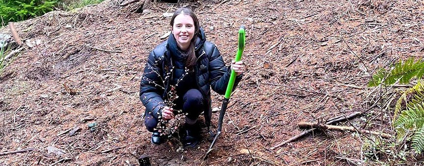 Ziptrek employee planting a native tree