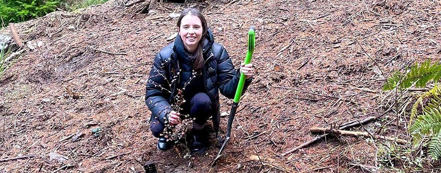 Ziptrek employee planting a native tree